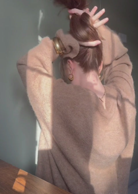 Video of woman styling her hair with the Banana Clip in Honey wearing a brown sweater