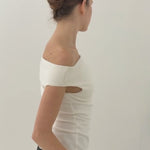 Woman with brunette hair styled in an up do secured with the French Pin in Gold wearing a white, off the shoulder top against a white background